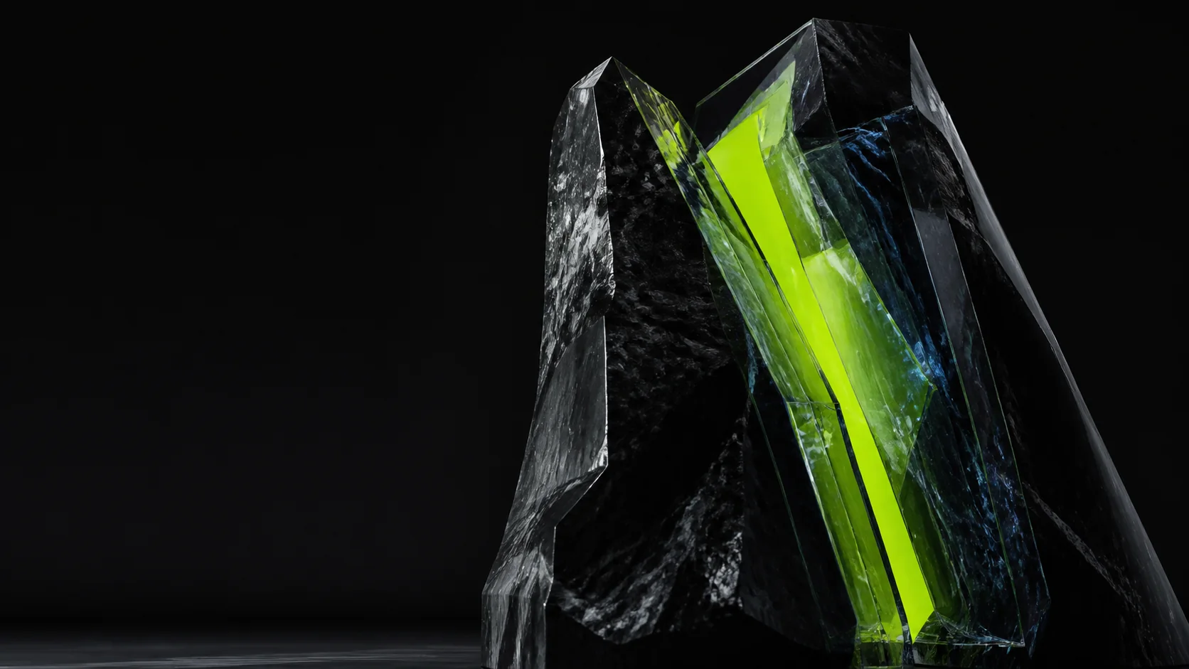 Abstract black glass sculpture illuminated by a vivid green core